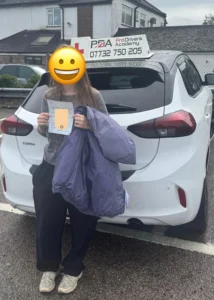 Learner driver who passed her driving test with Pro Drivers Academy, photographed at the chingford driving test centre carpark.