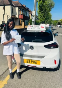 student has passed her manual driving test and poosing with her certificate in highams park 