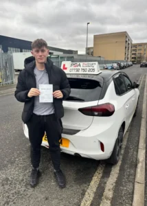 posing in jubilee avenue in highams park with his pass certificate after passing his driving test 