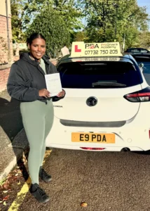posing in forest avenue with her pass certificate near Pro Drivers Academy learner car after passing her manual driving test.